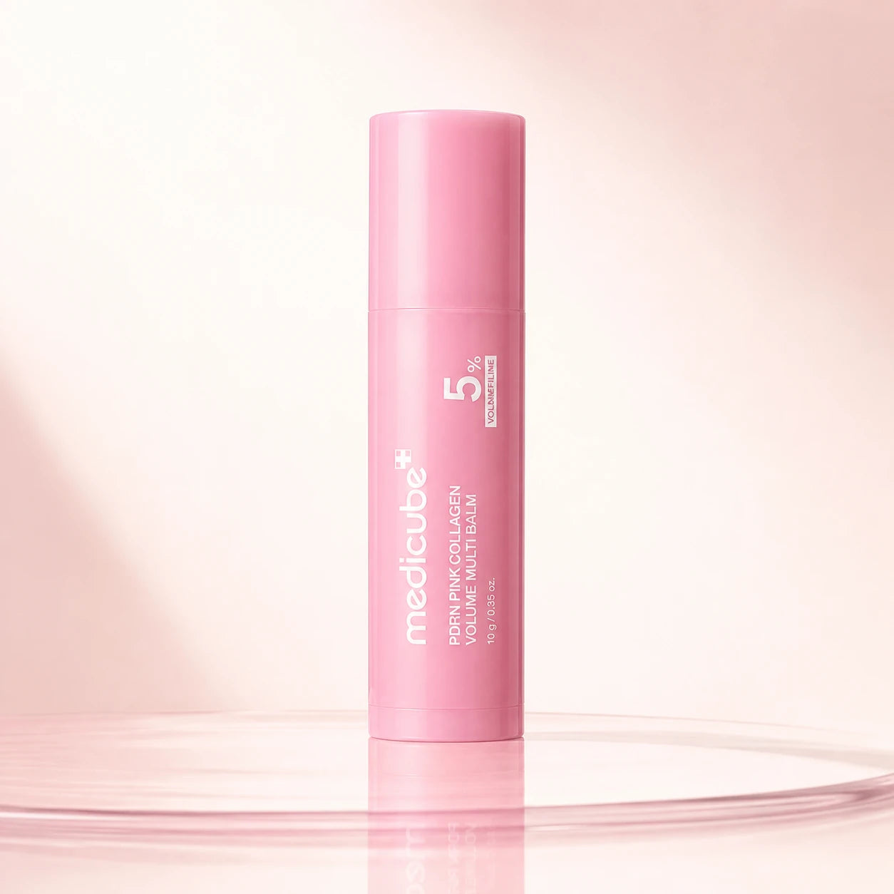 medicube PDRN Pink Collagen Volume Multi Balm 10g closed pink stick on an ivory background