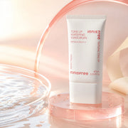 Innisfree Tone Up Watering Sunscreen SPF50+ PA++++ 60ml on a pink glass pedestal by water