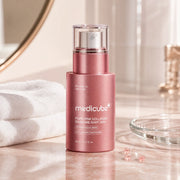 medicube PDRN Pink Collagen Exosome Shot 2000 on a blush bathroom vanity