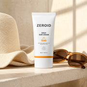 ZEROID Daily Sun Cream SPF50+ PA++++ 50ml on a sunlit stone shelf with hat and sunglasses