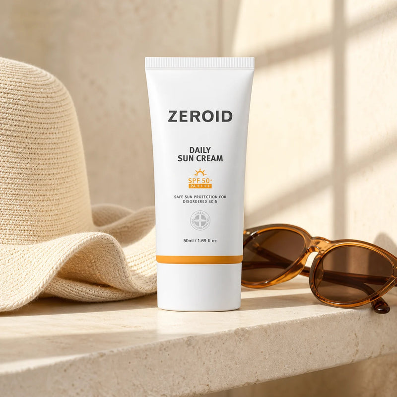 ZEROID Daily Sun Cream SPF50+ PA++++ 50ml on a sunlit stone shelf with hat and sunglasses