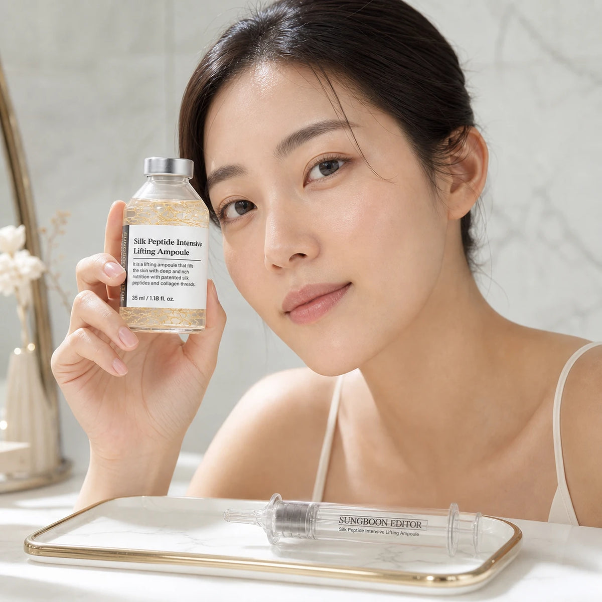 Woman holding SUNGBOON EDITOR Silk Peptide Intensive Lifting Ampoule 35ml