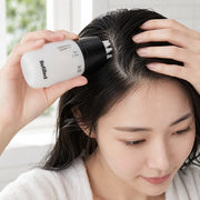 Woman applying Refilled Hair Recovery Cytokine Booster Pro to the scalp with silicone massager