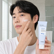 Man applying COSRX Ultra-Light Invisible Sunscreen to his cheek