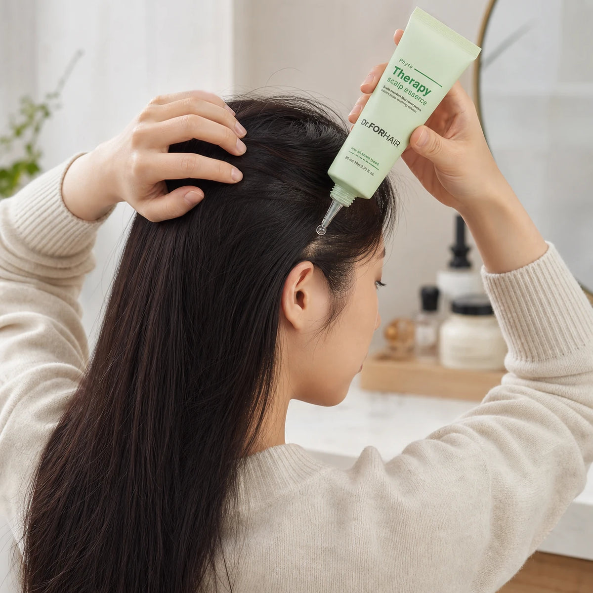 Woman applying Dr.FORHAIR Phyto Therapy Scalp Essence directly along a scalp part
