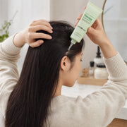 Woman applying Dr.FORHAIR Phyto Therapy Scalp Essence directly along a scalp part