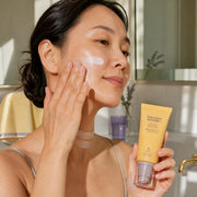 Woman applying haruharu wonder Black Rice Moisture Airyfit Daily Sunscreen to face and neck
