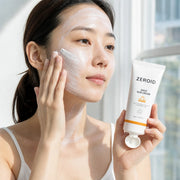 Woman applying ZEROID Daily Sun Cream SPF50+ PA++++ mineral sunscreen to face and neck