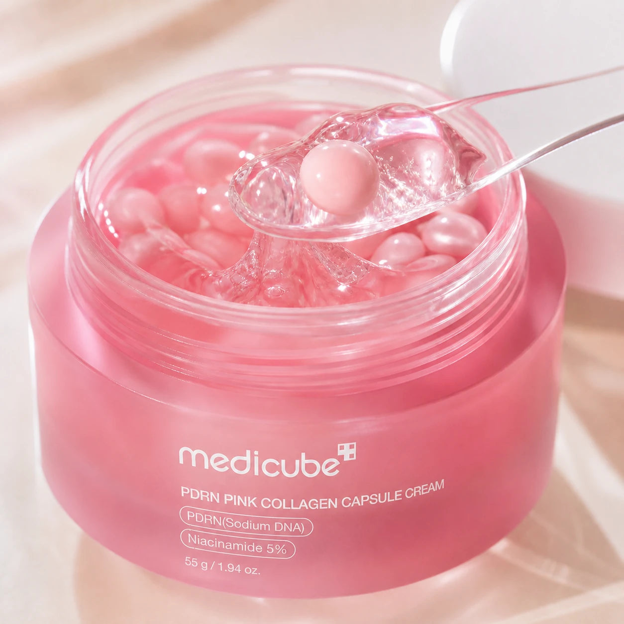 Clear gel and pearl-pink capsule texture of medicube PDRN Pink Collagen Capsule Cream