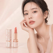 ProtoClinical k-beauty [DEAR DAHLIA] Blooming Edition Lip Paradise Sheer Dew Tinted Lipstick 3.4g close-up of a nude beige lipstick bullet in a slim taupe tube on a pale ivory background