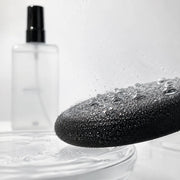 3CE Makeup Fixer Mist clear droplets on a makeup puff