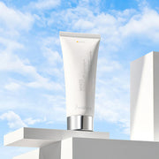 9wishes White Tone-Up Body Serum SPF21 150ml tube against a blue sky