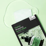 ProtoClinical k-beauty MEDIHEAL Teatree Wrapping Serum Mask 25ml X 10ea shown in a wide flat-lay product shot with dark packaging centered on a green background