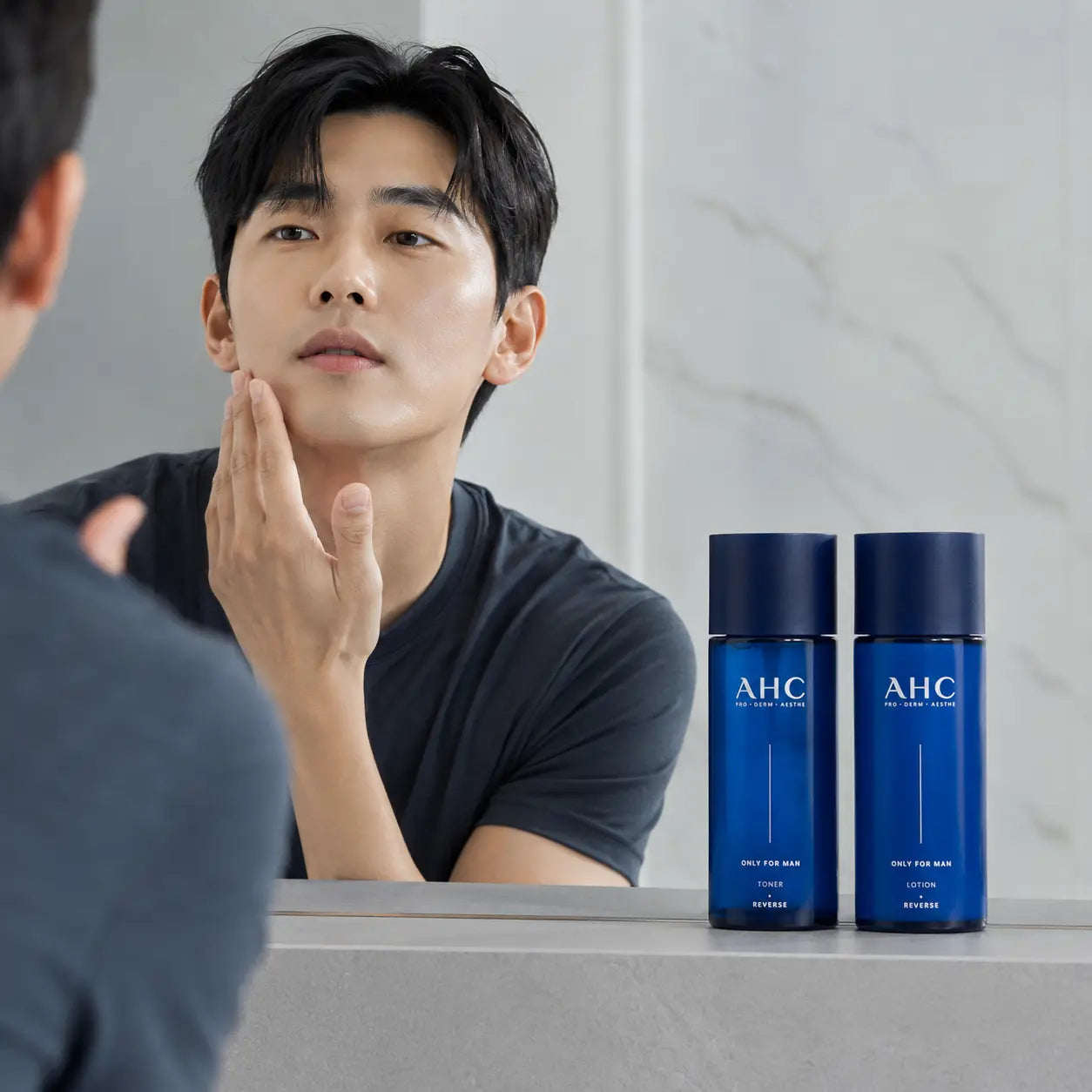 Man pressing AHC Only For Man lotion along the jawline after shaving