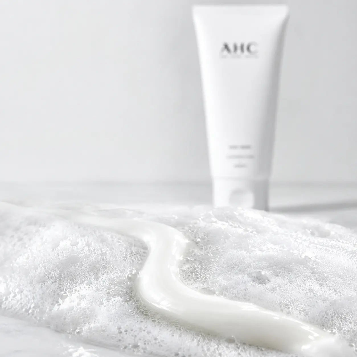 Pearly AHC cream cleanser transforming into dense white foam