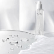 Clear AHC cleansing oil transitioning into a thin milky emulsion