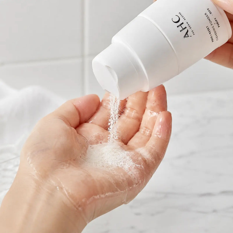 AHC PREP + RESET Cleansing Powder dispensed into a wet palm