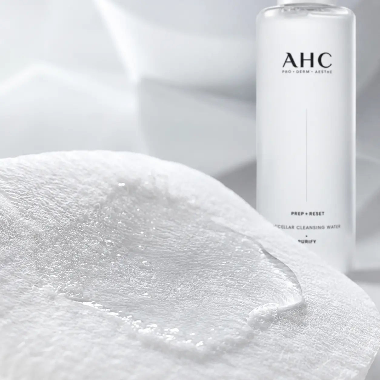 Clear micellar cleansing water saturating cotton fibers