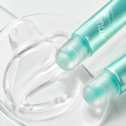 Macro view of the clear glossy texture and rounded applicators of Anua PDRN Lip Serum