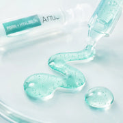 Macro texture of emerald-aqua Anua capsule serum with microcapsules