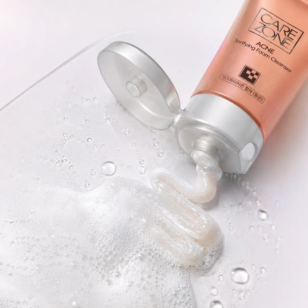 Macro view of the pearly cream cleanser lathering into fine white foam