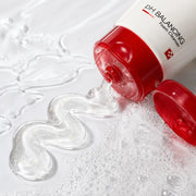 Macro view of the clear gel with tiny golden particles transitioning into fine lather