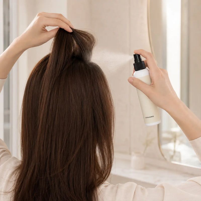 CHAHONG Fix Volume Hair Spray applied to lifted crown roots from 20 to 30 cm away