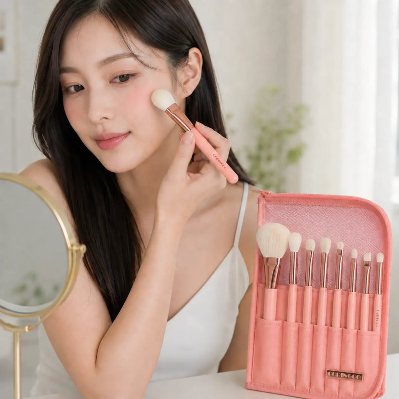 Applying blush with CORINGCO Rose Book brush beside standing pouch