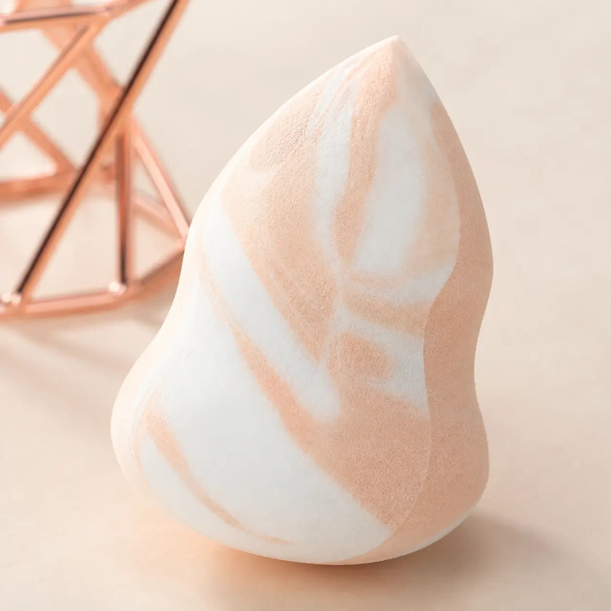 Macro detail of the latex free sponge pore texture, curved cut and peach marble pattern