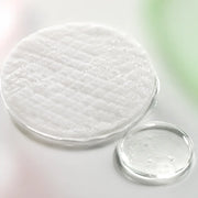 Macro of an essence soaked embossed peeling pad and clear cica hyaluronic ampoule texture