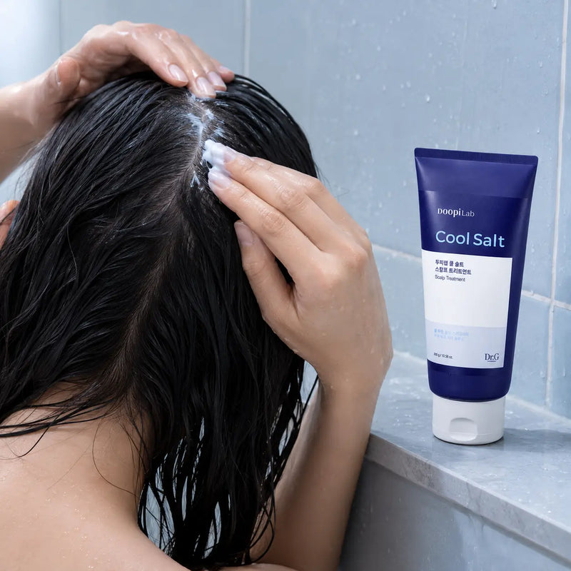 Applying Dr.G DoopiLab Cool Salt Treatment to wet scalp and hair
