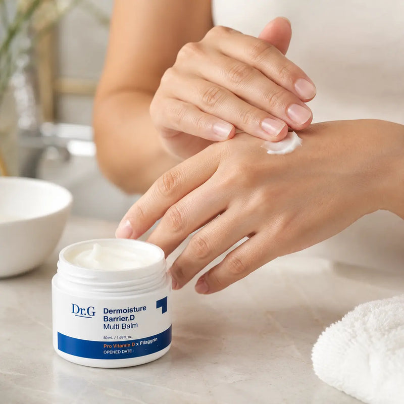 Hands applying Dr.G Dermoisture Barrier.D Multi Balm to dry areas
