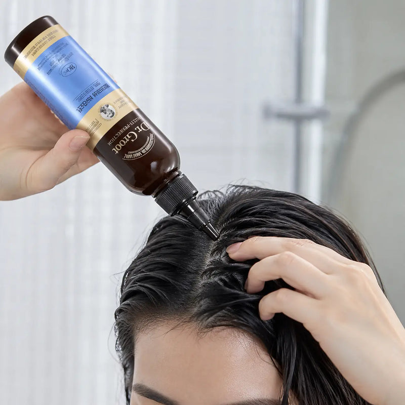 Applying Dr.Groot Multi-Perfection Biotin Ampoule Treatment to wet scalp