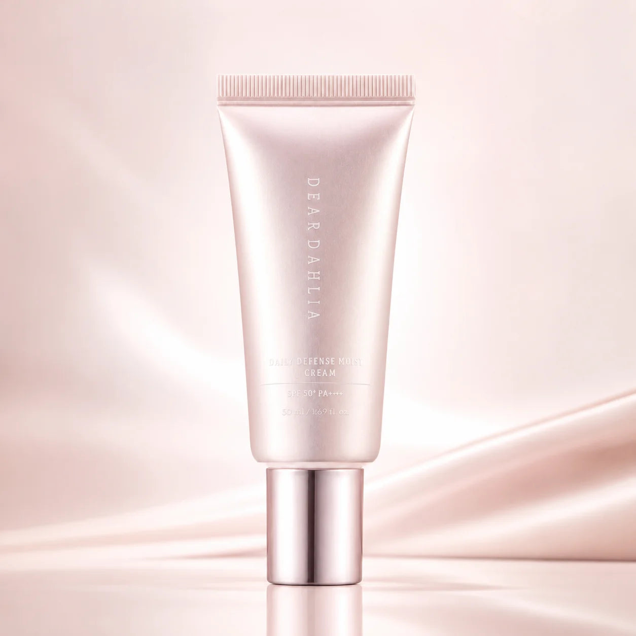 ProtoClinical k-beauty [DEAR DAHLIA] Daily Defense PDRN BB Cream SPF40 20ml (4colors) shown as a single rose-beige squeeze tube with a metallic cap, centered upright on a soft blush reflective background