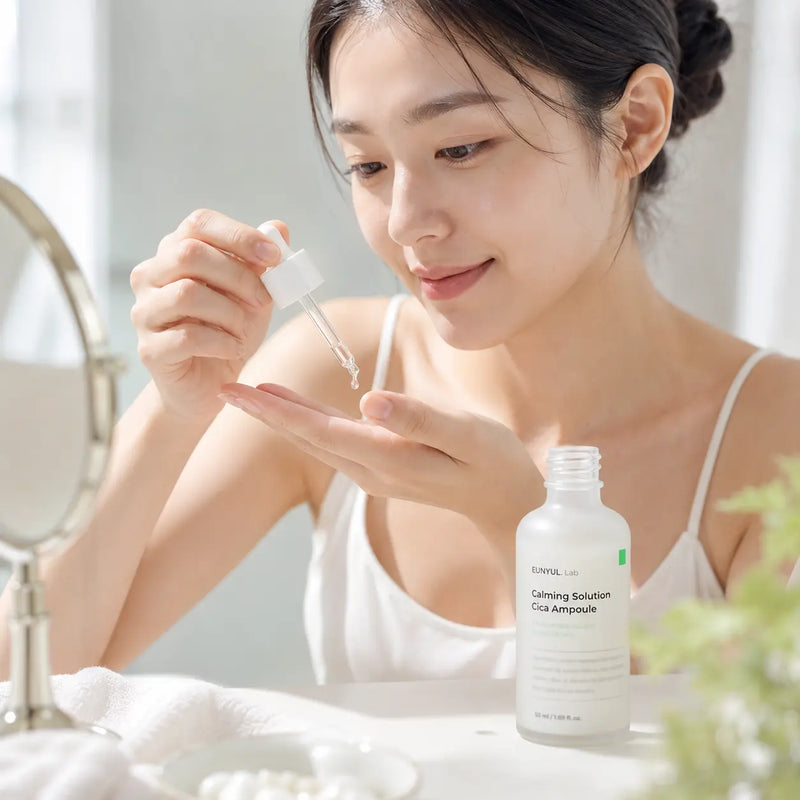 Woman dispensing EUNYUL.Lab Calming Solution Cica Ampoule onto fingertips