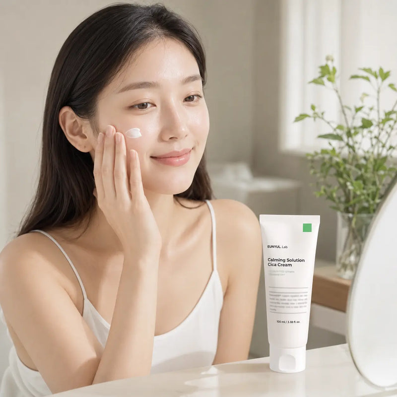 Woman applying EUNYUL.Lab Calming Solution Cica Cream to her cheek