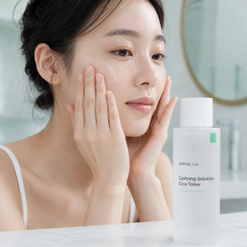 Model pressing EUNYUL Lab Calming Solution Cica Toner into skin