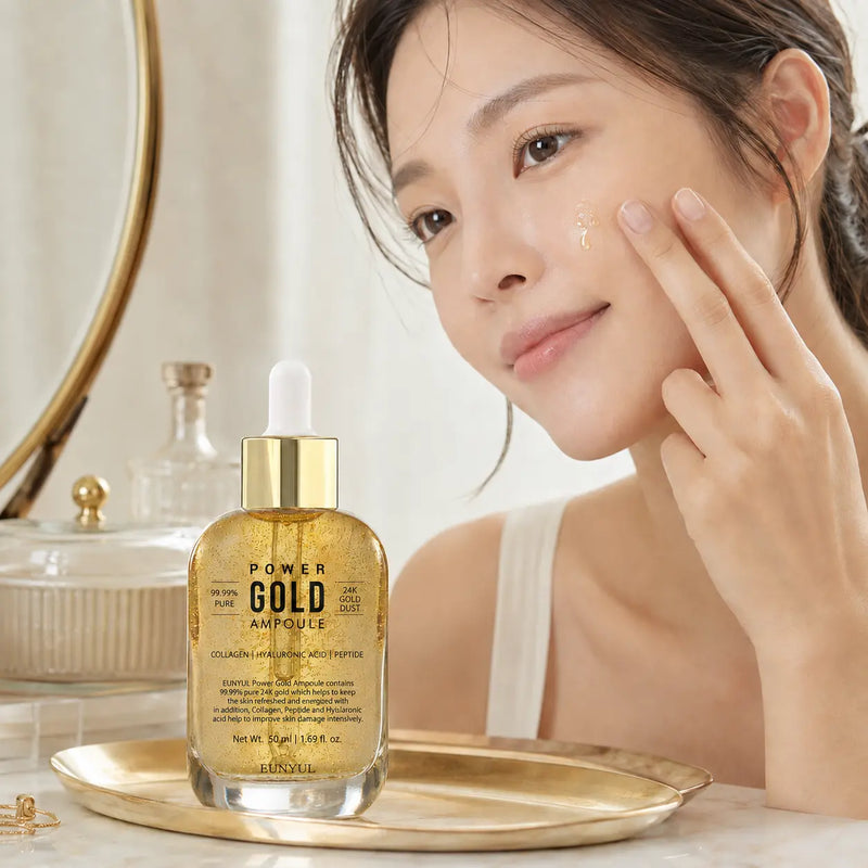 Applying EUNYUL Power Gold Ampoule to the cheek
