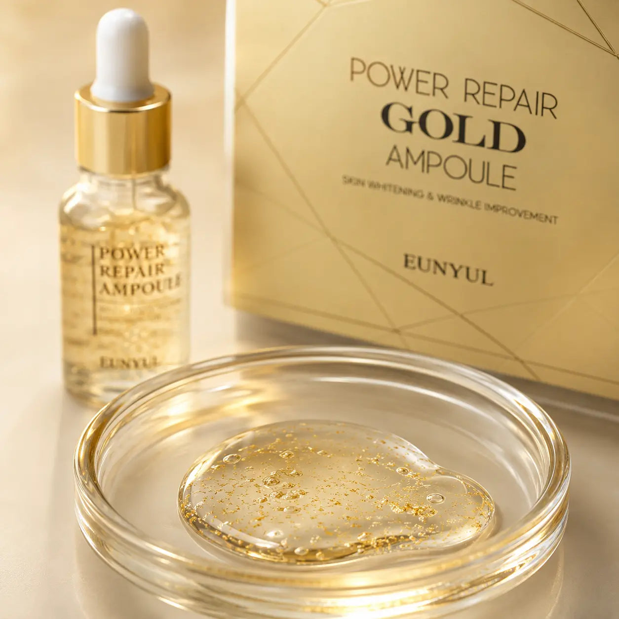 Macro view of translucent EUNYUL Gold Ampoule serum with suspended gold flecks