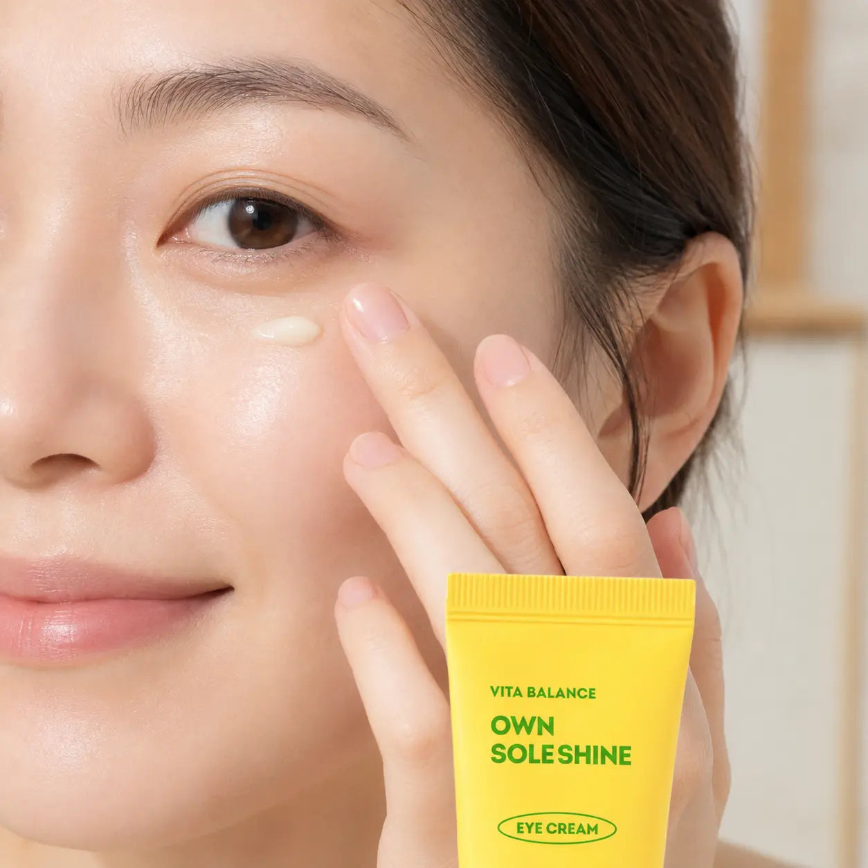 Model tapping EUNYUL Own Sole Shine Eye Cream under the eye