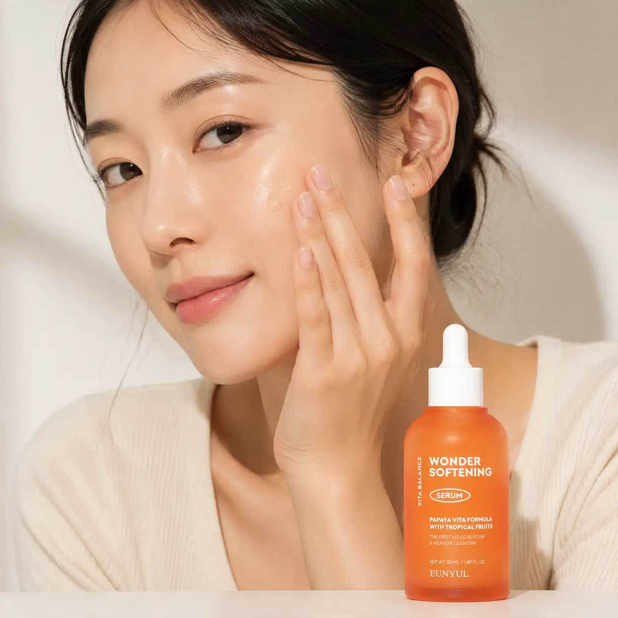 Applying EUNYUL Wonder Softening Serum to the cheek