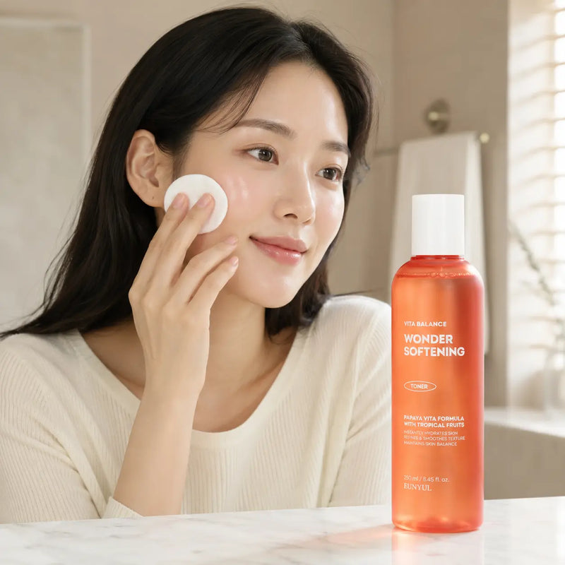 Applying EUNYUL Wonder Softening Toner with a cotton pad