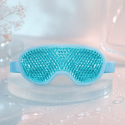 Blue reusable gel-bead eye mask on a frosted pedestal