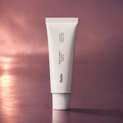 Huxley Hand Cream Sunset Fog 30 ml tube on a mauve sunset background