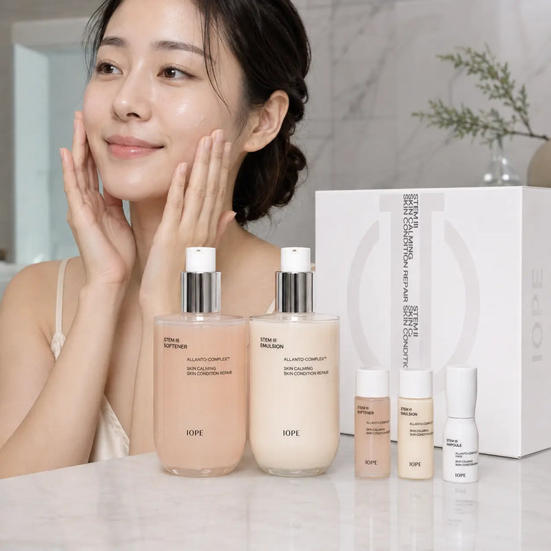 Woman pressing in IOPE Stem III skincare beside five-piece set