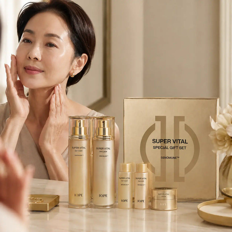 Woman applying IOPE Super Vital skincare beside five-piece set