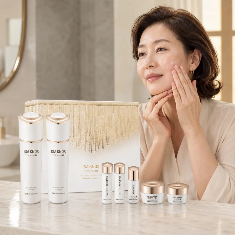 Woman applying ISA KNOX TE'RVINA AD skincare beside seven-piece set