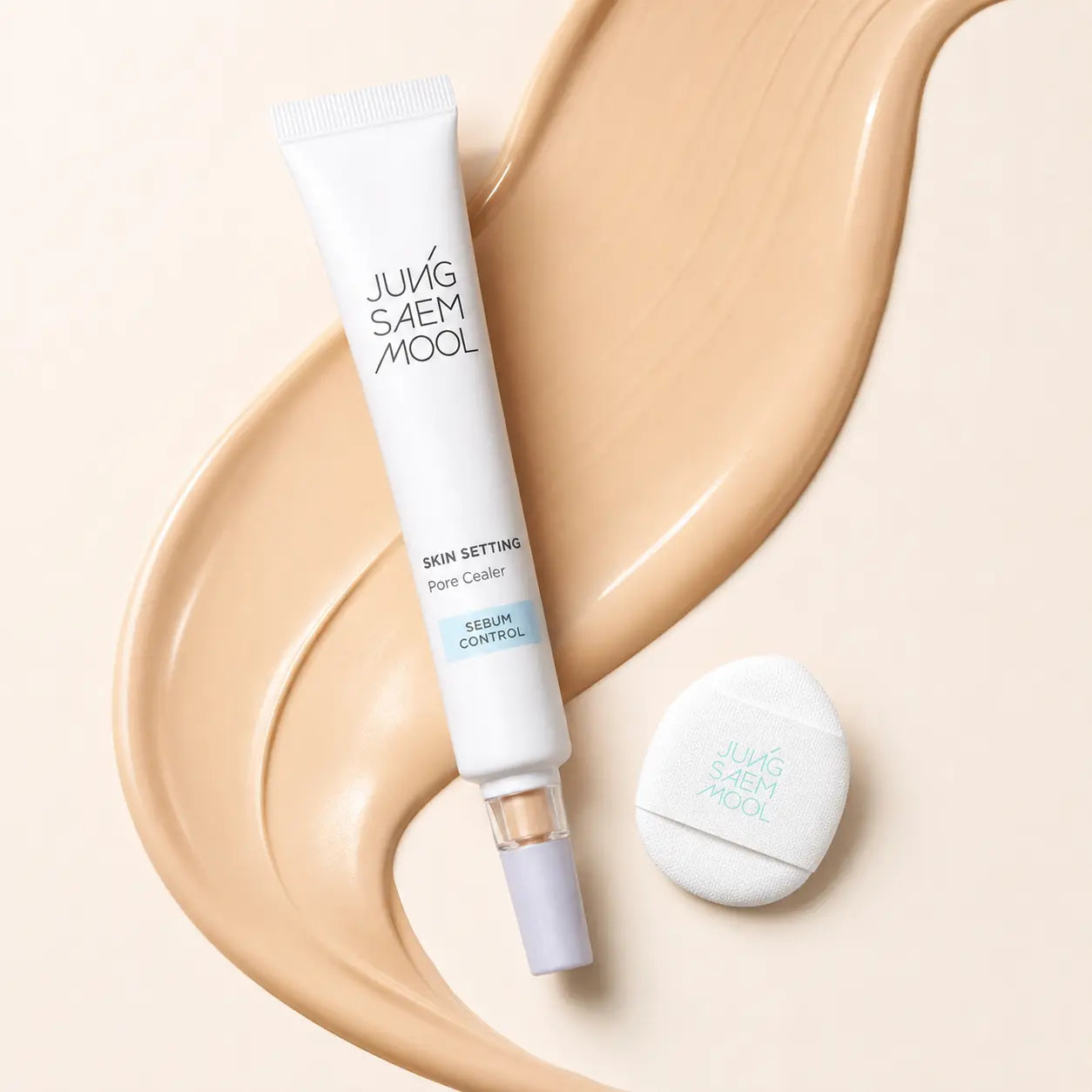 Macro view of silky beige Pore Cealer primer texture with mini puff