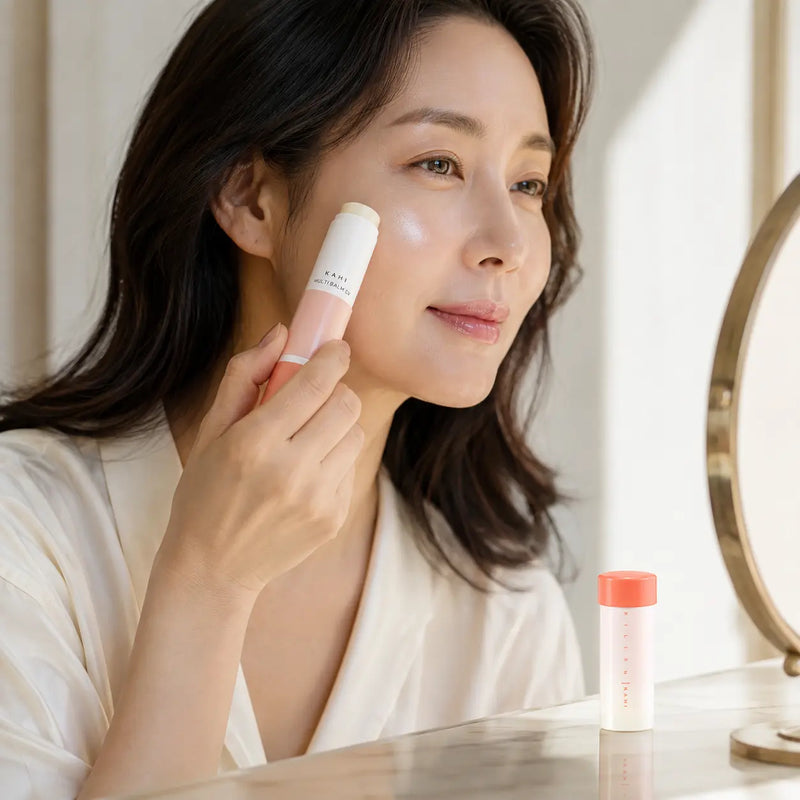 Woman applying KAHI Multi Balm CV to the high point of her cheek
