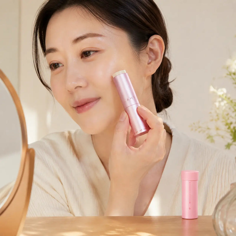 Woman applying classic KAHI Multi Balm to a dry cheek area